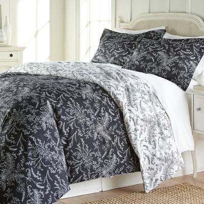 Angled View of Wild Winter Reversible Comforter Set in Black#color_wild-winter-black-with-white-flowers