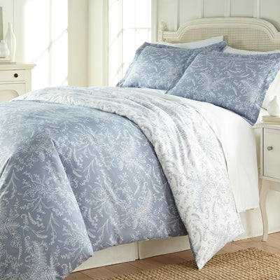 Angled View of Wild Winter Reversible Comforter Set in Blue#color_wild-winter-blue-with-white-flowers