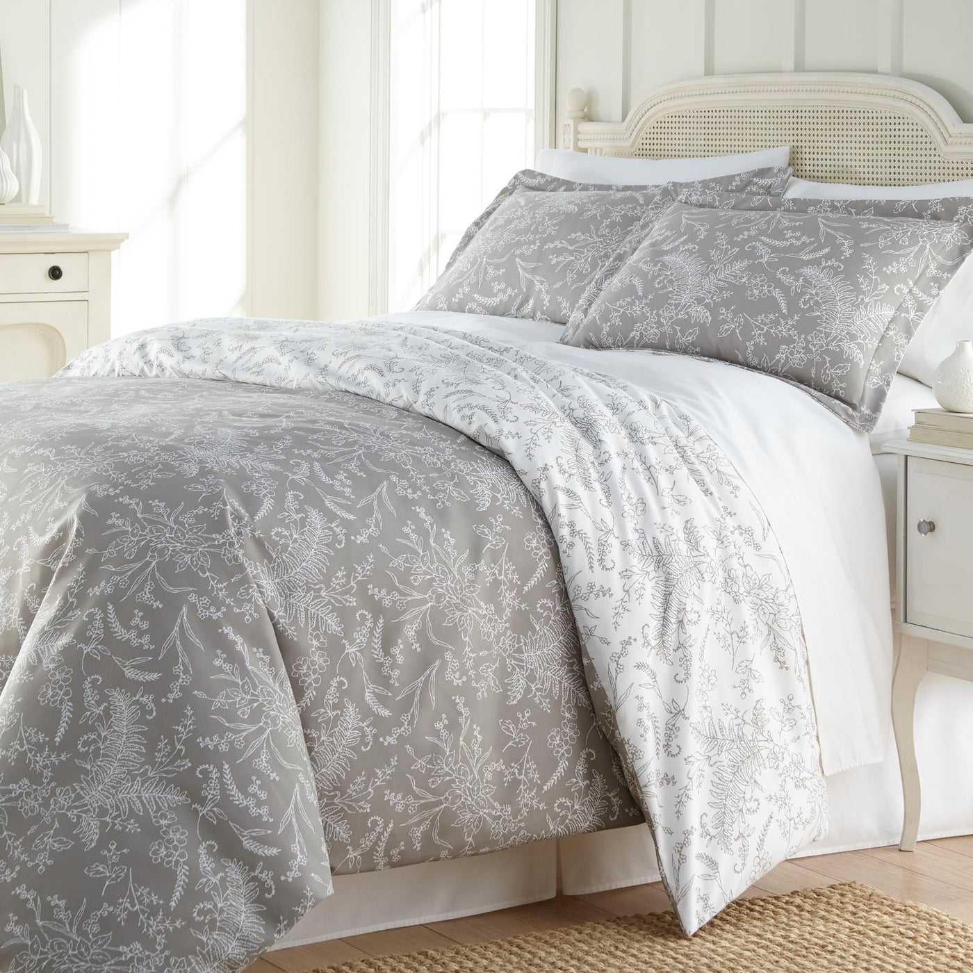 Angled View of Wild Winter Reversible Comforter Set in Grey#color_wild-winter-grey-with-white-flowers