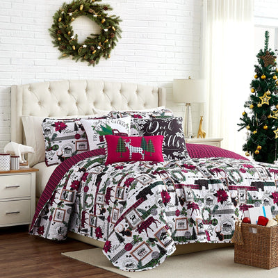 Front view of Merry Town 6-piece quilt bedding set showing holiday patchwork print and red plaid reverse on a styled bed