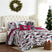 Front view of Merry Town 6-piece quilt bedding set showing holiday patchwork print and red plaid reverse on a styled bed