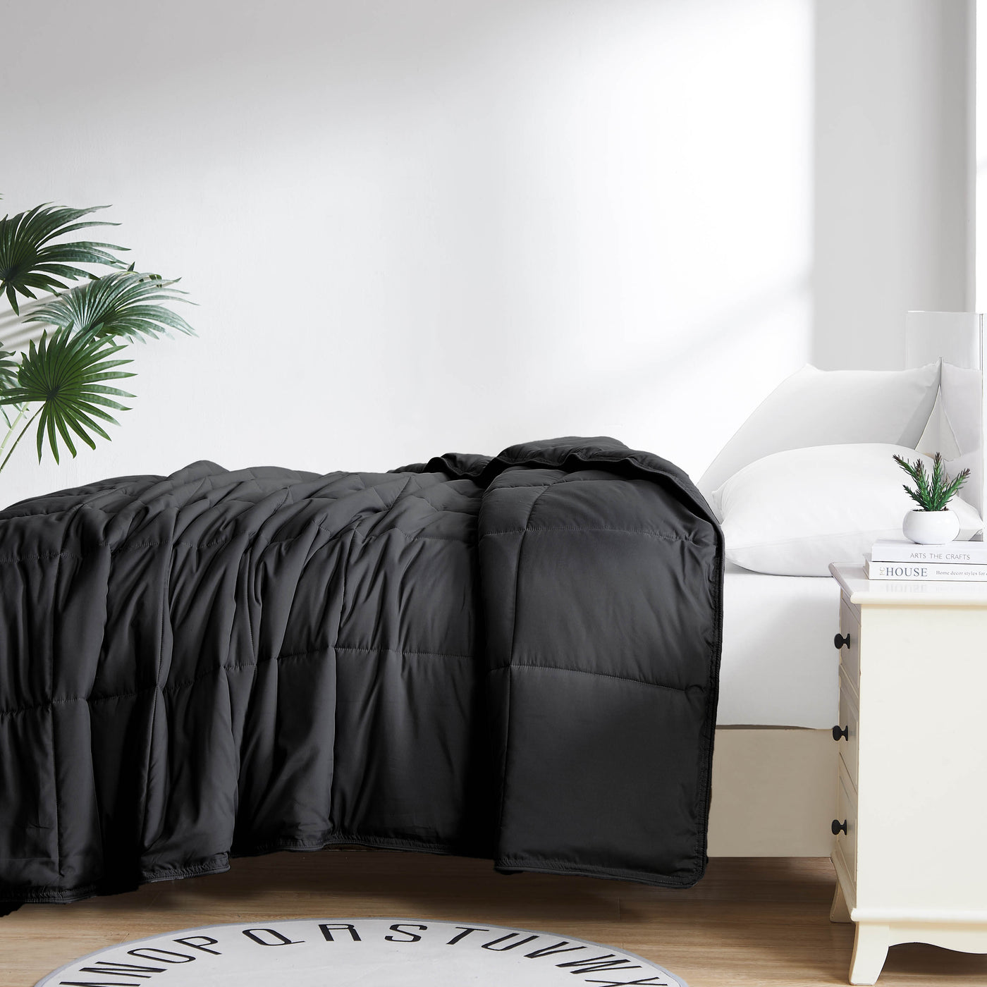 Side View of Down Alternative Comforter in Black#color_black