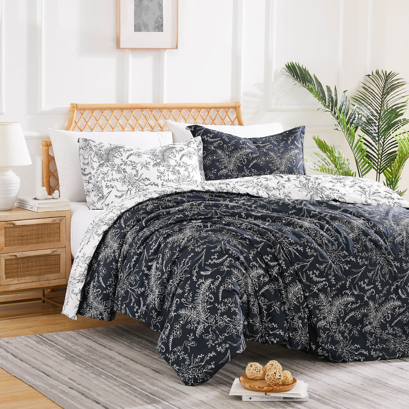 Angled View of Wild Winter Reversible Comforter Set in Black#color_wild-winter-black-with-white-flowers