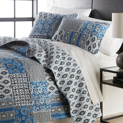 Angled View of World Song Quilt Set in Blue#color_world-song-blue